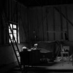 Attic Lighting - grayscale photo of a room with a table and chairs