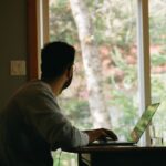 Home Office - man in gray hoodie using laptop computer