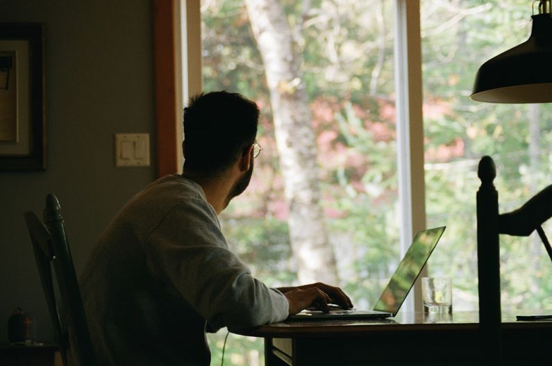 Home Office - man in gray hoodie using laptop computer
