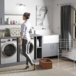 Laundry Room - a woman standing in a laundry room next to a washer and dryer