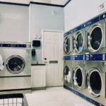 Laundry Room - a row of washers and dryers in a laundry room