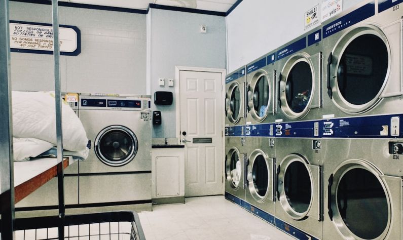 Laundry Room - a row of washers and dryers in a laundry room